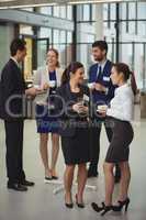 Group of businesspeople interacting with each other in the lobby