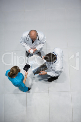 Doctors and surgeon discussing x-ray while having coffee