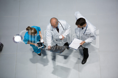 Doctors and surgeon discussing x-ray while having coffee