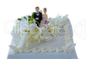 Wedding cake with couple figurines and flowers