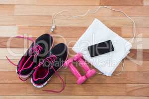 Mobile phone with headphones, shoes, towel and dumbbells