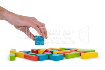 Hand arranging building blocks