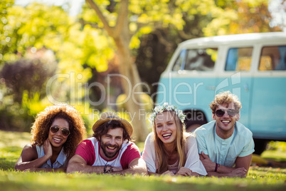 Portrait of happy friends lying on grass together