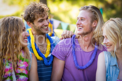 Friends interacting with each other in park Friends interacting with each other in park