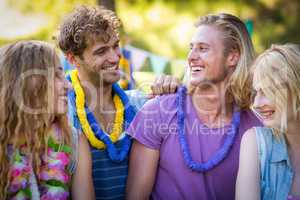 Friends interacting with each other in park