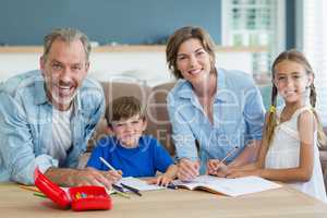 Siblings getting help with homework from parents