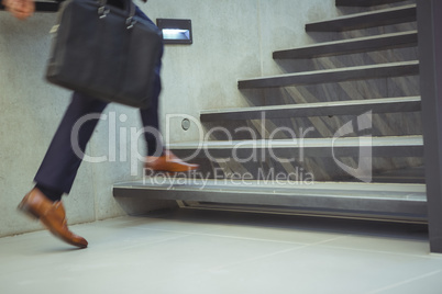 Businessman climbing stairs at office