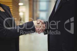 Business executives shaking hands at office
