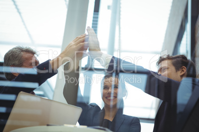 Businesspeople giving a high five to each other