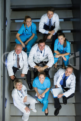 High angle view of doctors and surgeons sitting on staircase