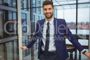 Portrait of handsome businessman standing in corridor