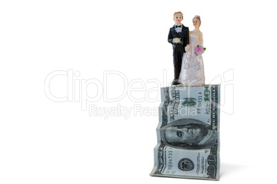 Wedding couple figurines on US dollar banknote