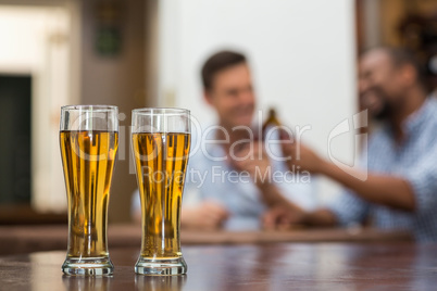 Beer glasses kept on wooden table