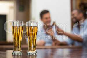 Beer glasses kept on wooden table