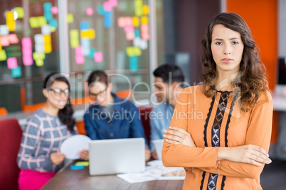 Portrait of female graphic designer standing with arms crossed