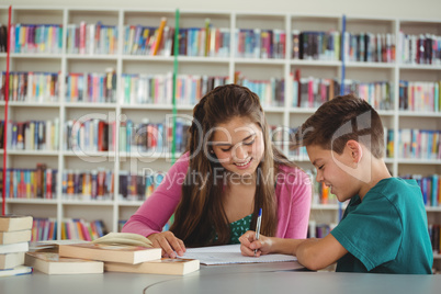 School kids doing homework in library at school