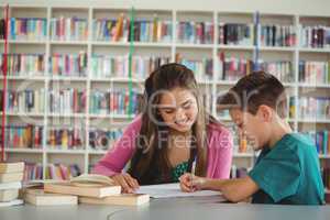 School kids doing homework in library at school