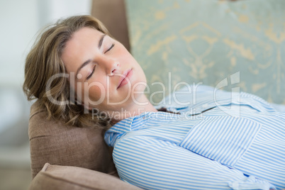 Woman sleeping on couch in living room at home