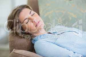 Woman sleeping on couch in living room at home