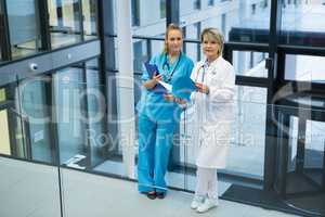 Female doctor and nurse standing in corridor