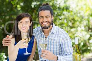 Couple holding glasses of wine in a restaurant