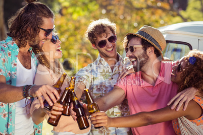 Group of friends toasting beer bottles