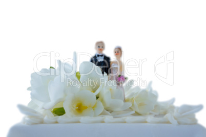 Wedding cake with couple figurines and flowers
