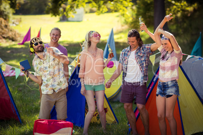 Group of friends having fun together at campsite