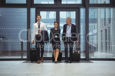 Businesspeople walking together with luggage Businesspeople walking together with luggage