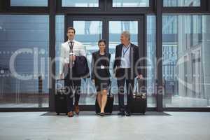 Businesspeople walking together with luggage