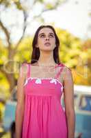 Thoughtful woman standing in park