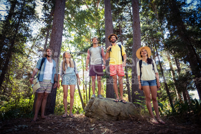 Group of friends standing together in forest