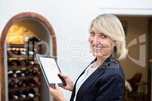 Businesswoman holding digital tablet in a restaurant