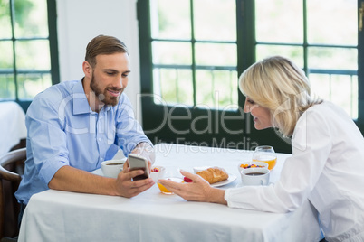 Executives using mobile phone in a restaurant