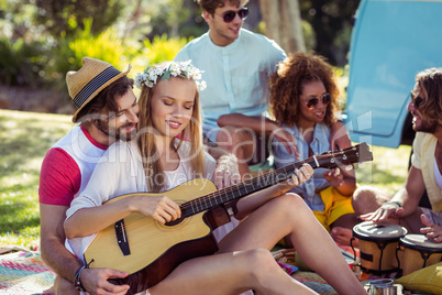 Group of friends having fun and playing music