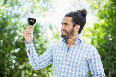 Man holding glass of wine in the park