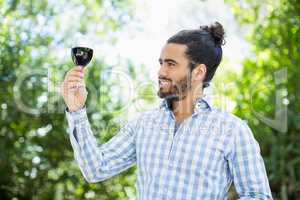 Man holding glass of wine in the park