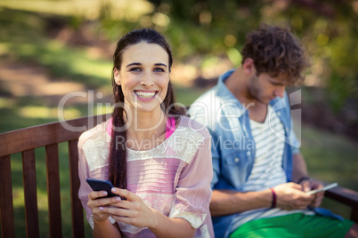 Woman using mobile phone in park