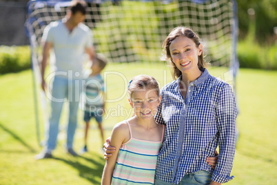 Portrait of mother and daughter standing in park