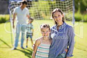 Portrait of mother and daughter standing in park