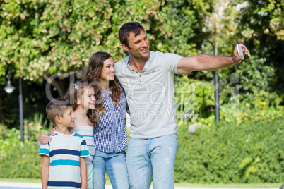 Happy family taking a selfie on mobile phone