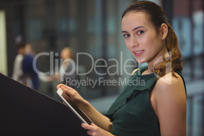 Businesswoman holding digital tablet at office Businesswoman holding digital tablet at office