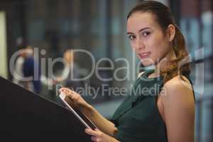 Businesswoman holding digital tablet at office