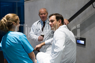 Doctors and surgeons interacting with each other on staircase
