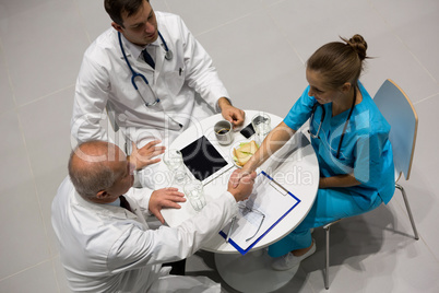 High angle view of doctors and surgeon shaking hands