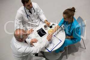 High angle view of doctors and surgeon shaking hands