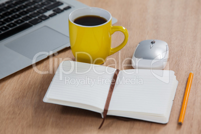 Cup of coffee with laptop, organizer, pencil and mouse