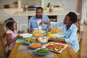 Family having meal on dinning table at home