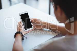 Schoolboy using mobile phone in classroom