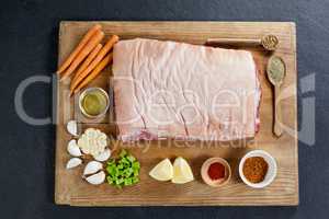 Beef brisket and ingredients on wooden board